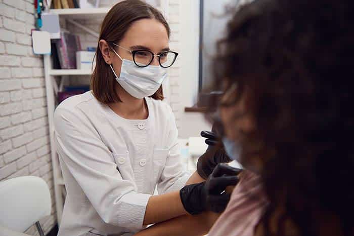 Doctor Vaccinating Patient