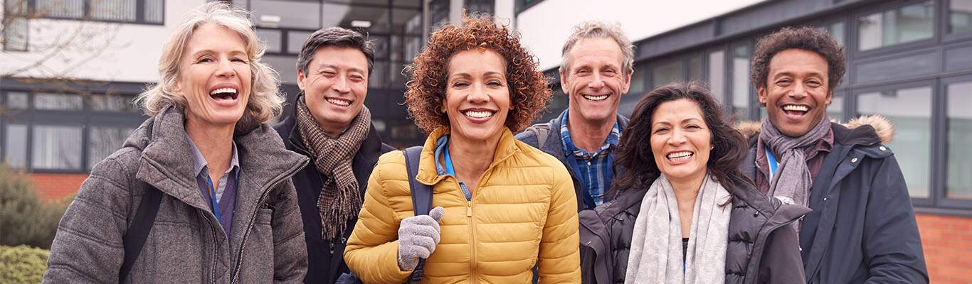 Middle aged paid clinical trial participants taking a picture outside