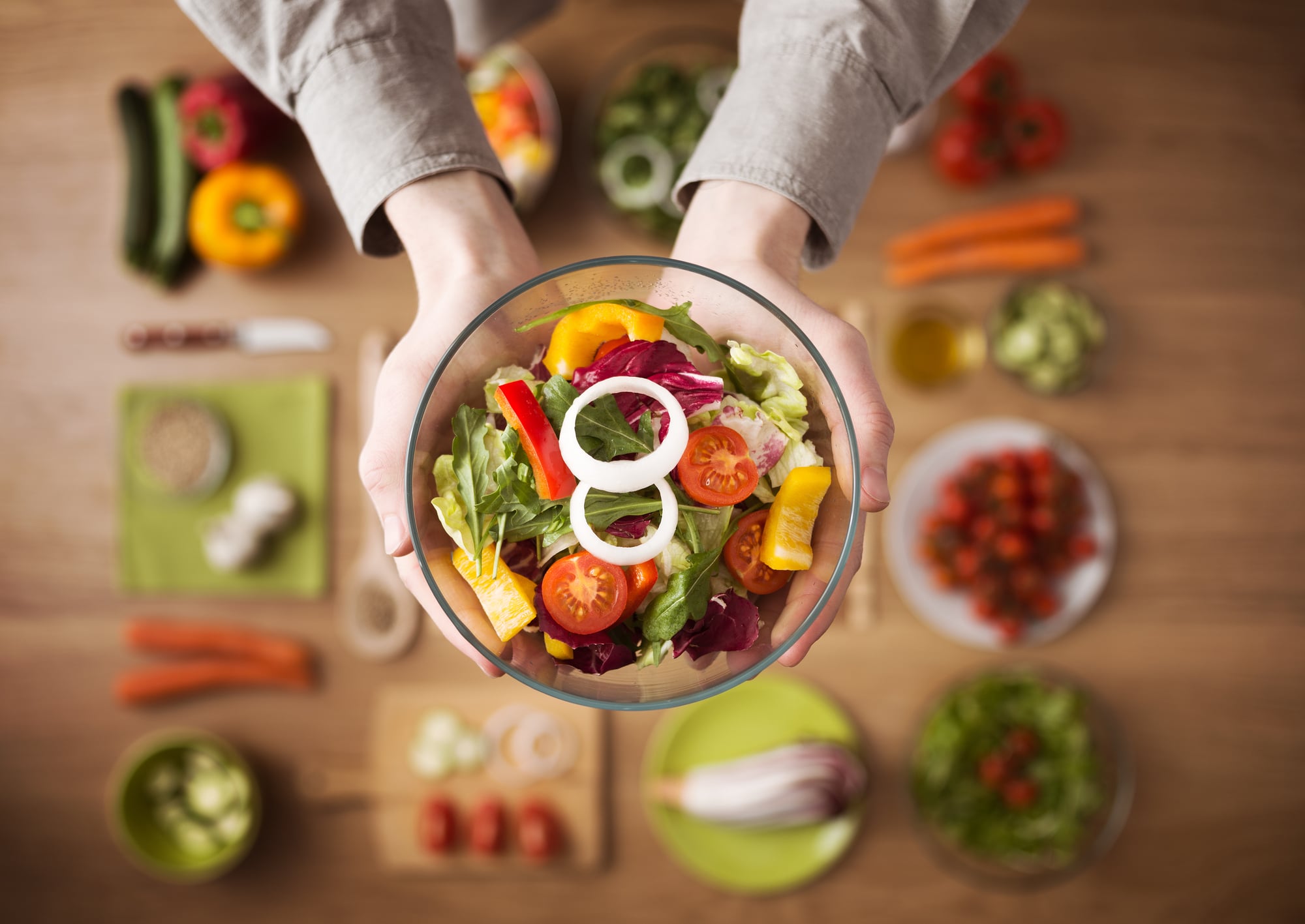 Paid clinical trial participant holding a bowl of salad.
