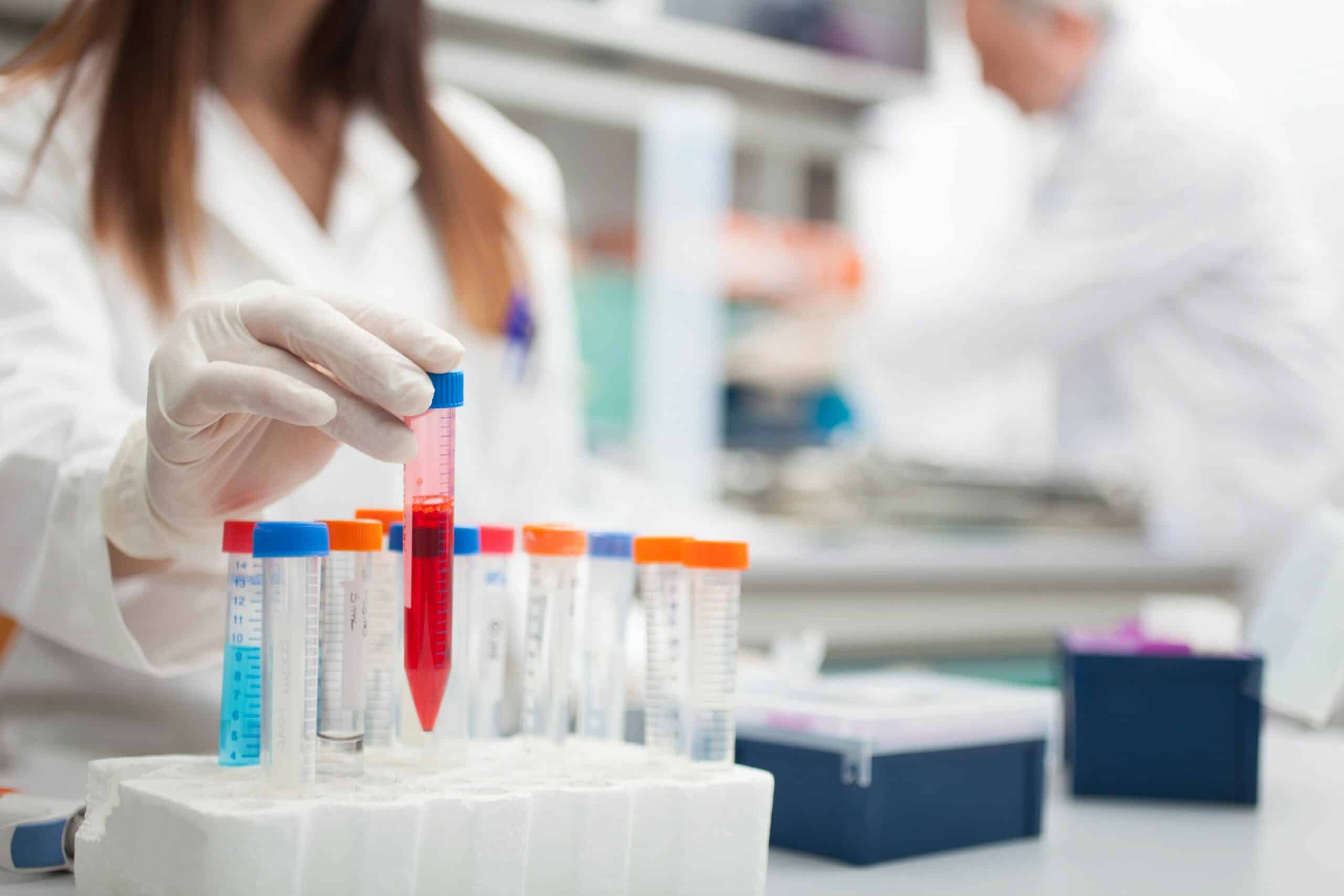 Clinical trial researcher organizing test tubes.