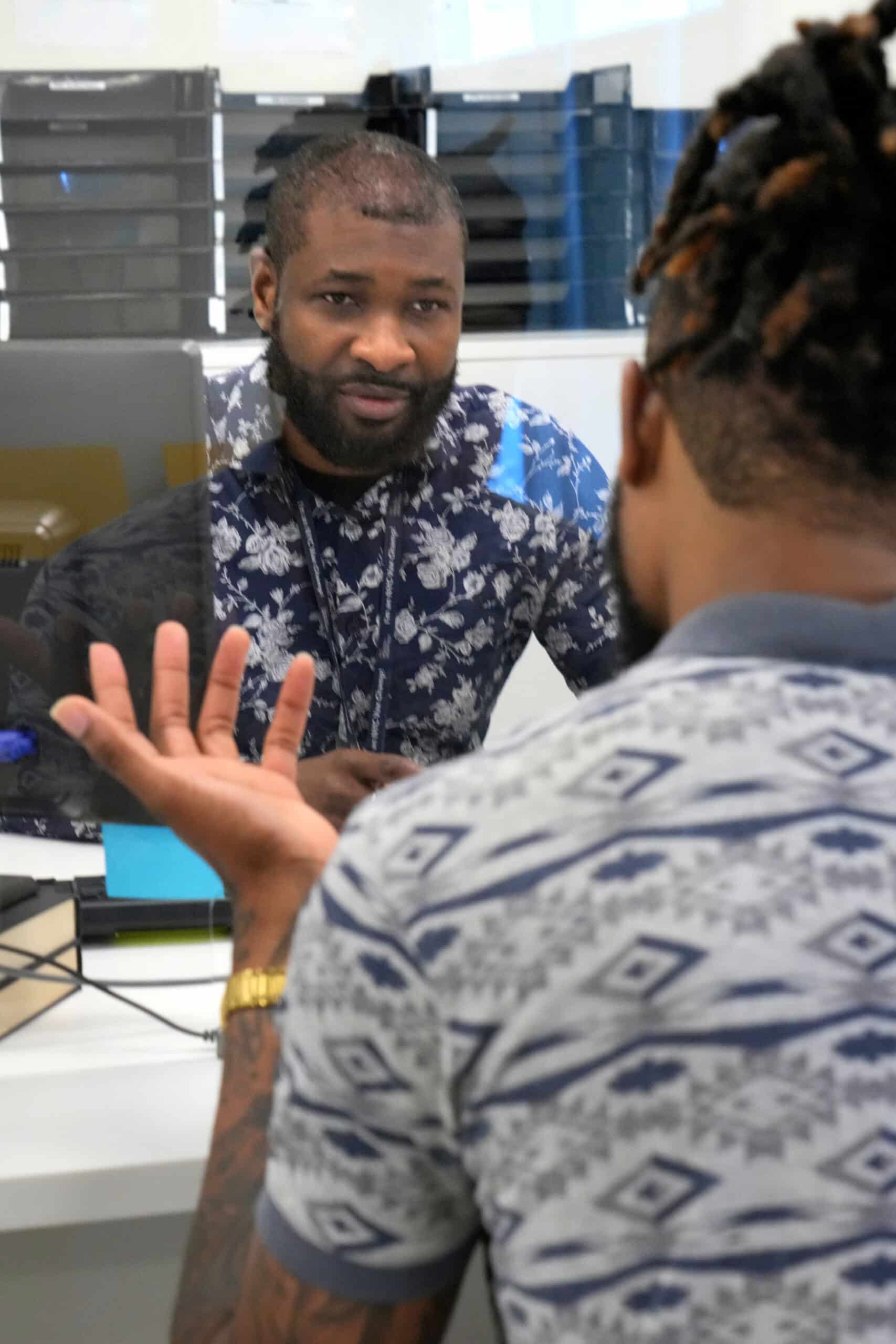 Paid clinical trial participant talking to their clinical trial advisor during the screening.