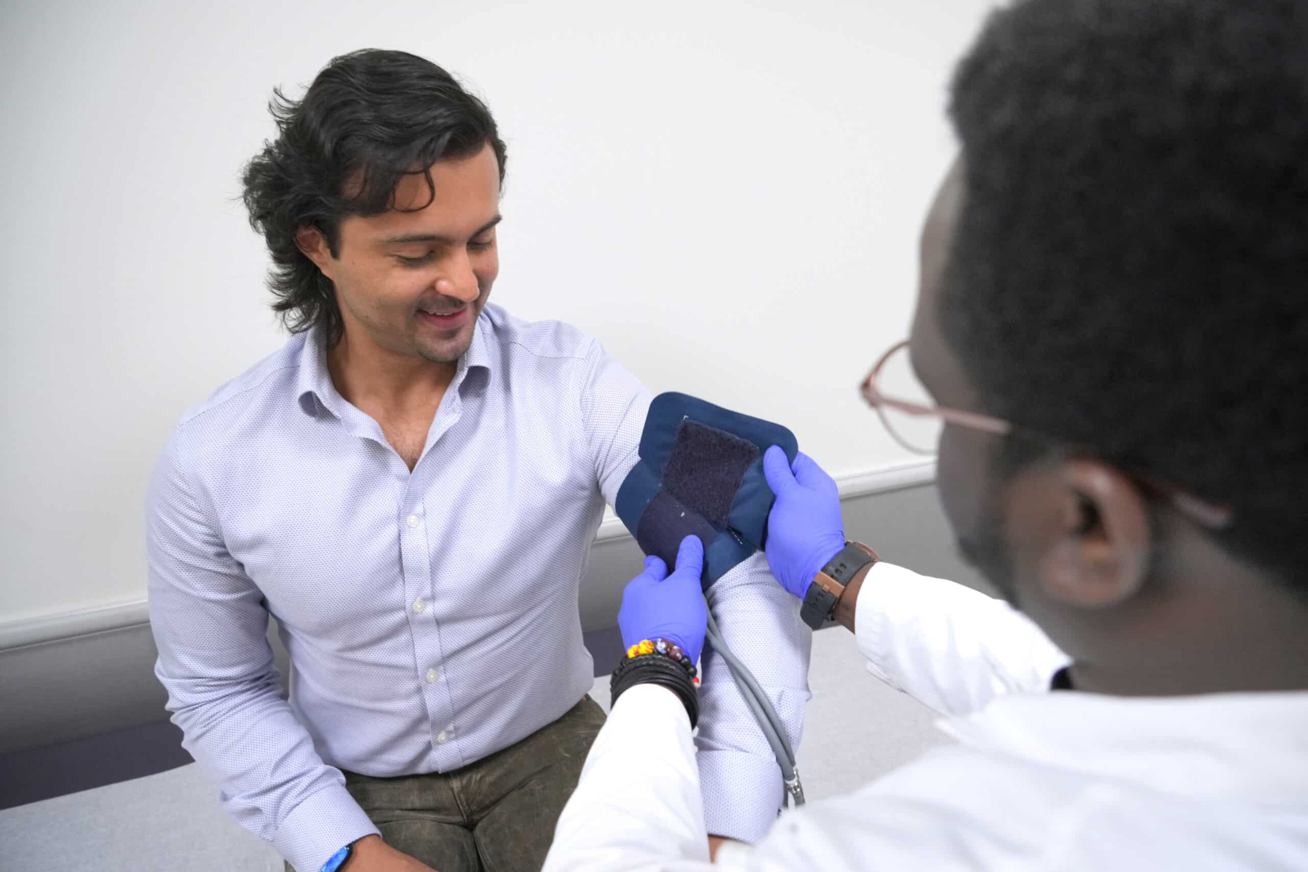 A man's blood pressure being checked at the paid clinical trial screening.