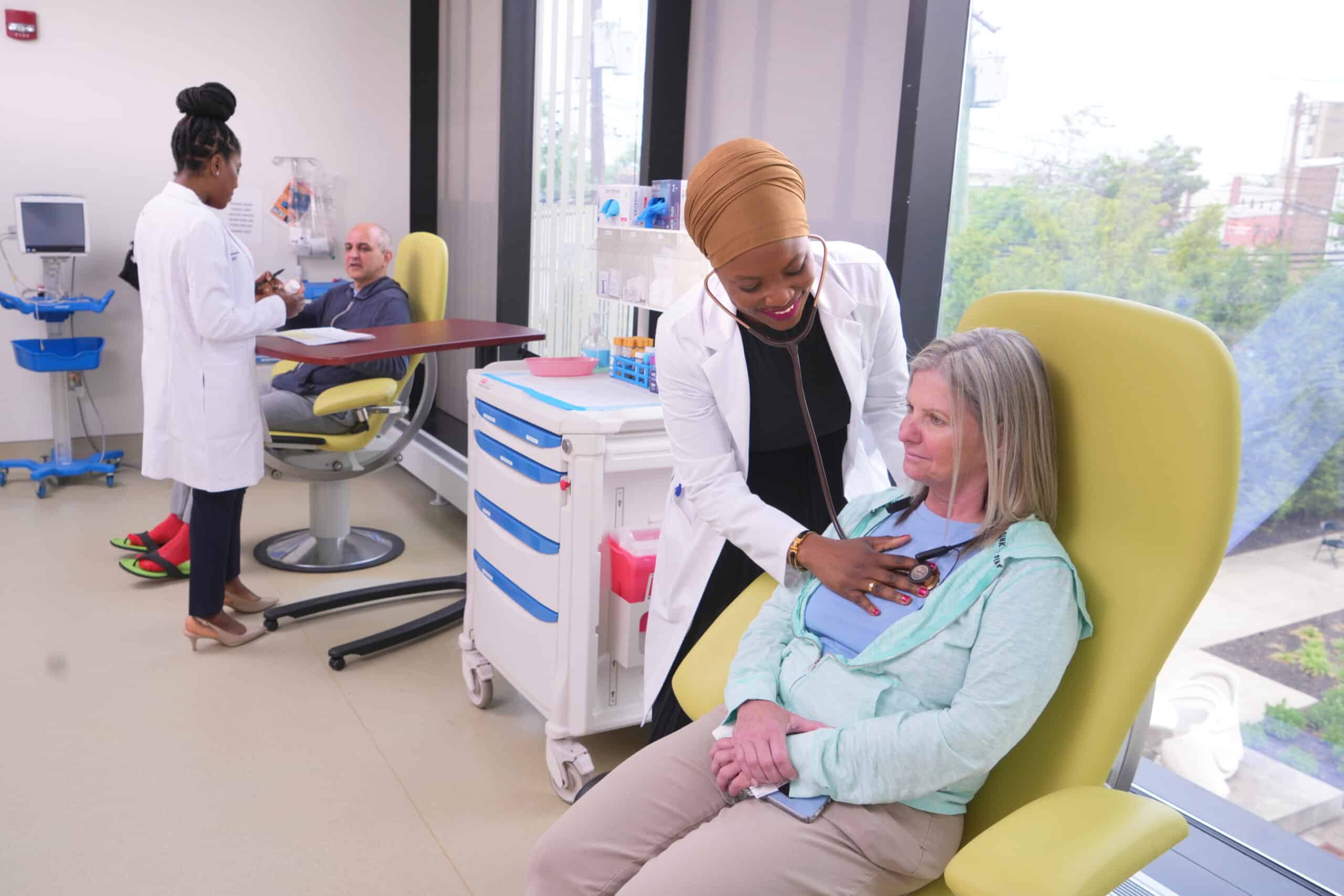 Paid clinical trial participants being checked by medical staff.