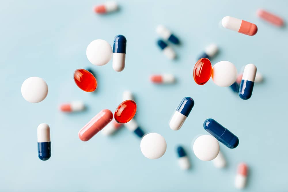Abstract picture of clinical trial drug pills flying in the air.