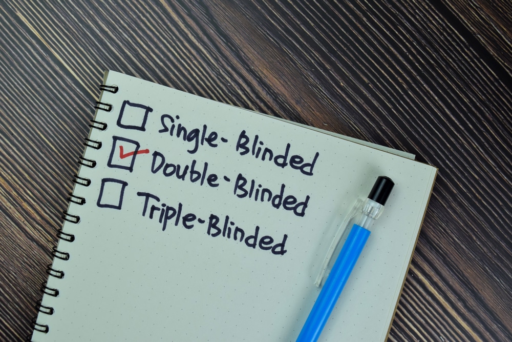 Notepad with 3 checkboxes - Single-blinded, Double-blinded and Triple-blinded. Double-blinded is checked off.