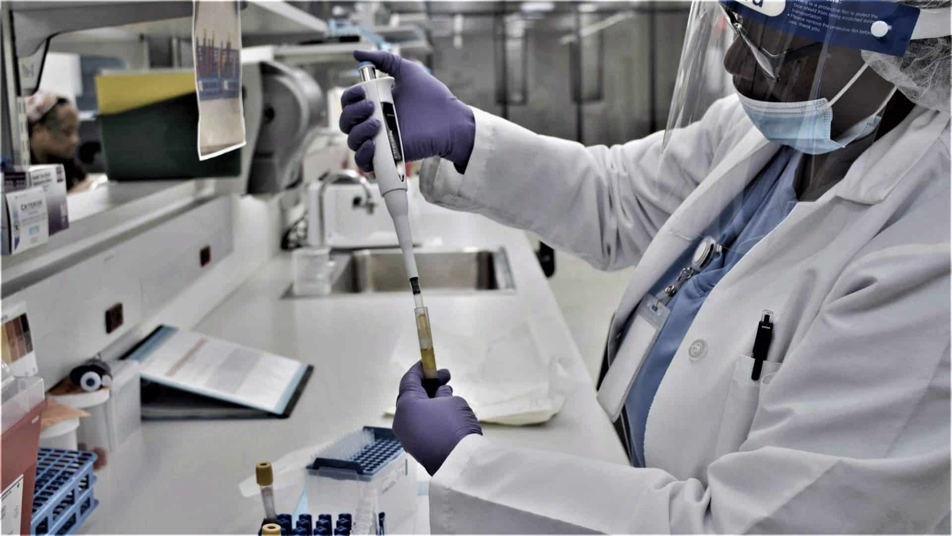 Clinical trial researcher testing samples in a laboratory.